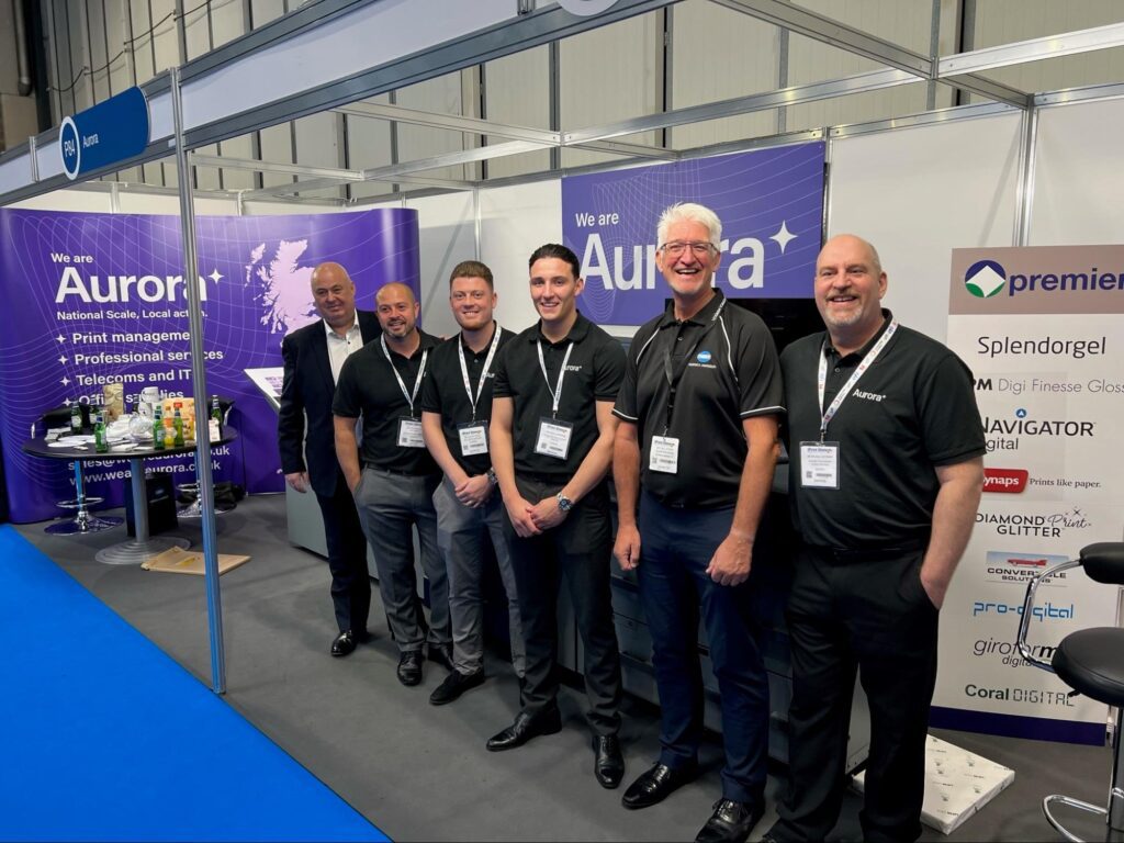 The Aurora Print Production Team at the Print Show Stand