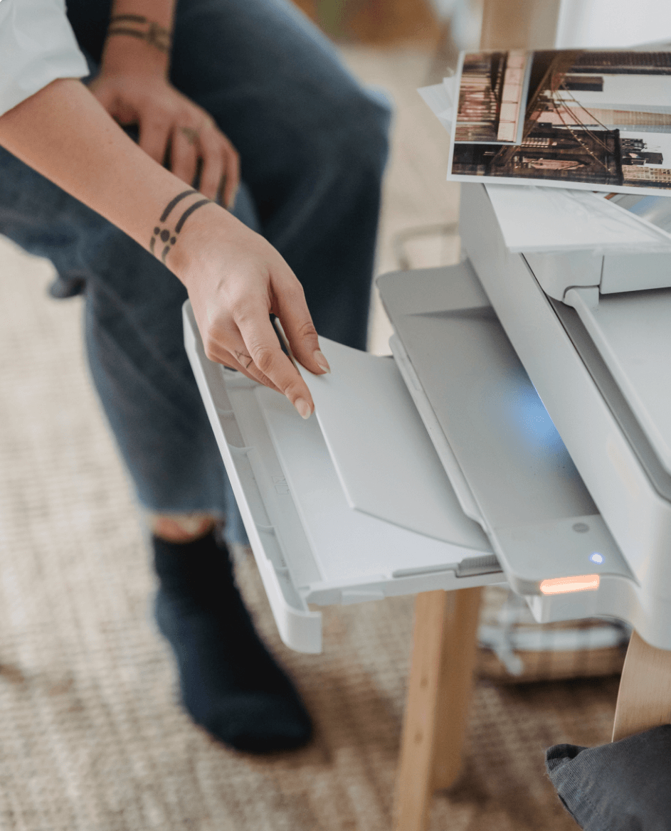Person inserting paper into printer