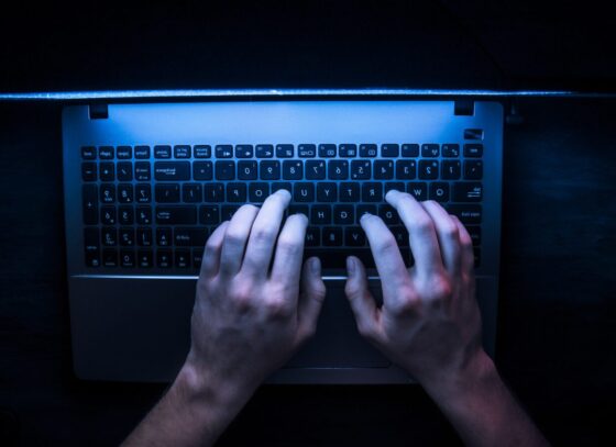 a person using a laptop in a dark room
